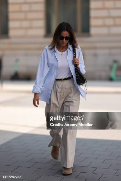 Elise Seitz seen wearing white tank top, black sunglasses, gold pearl necklace, a light blue SohoStudios shirt, black leather gold Celine Triomphe...