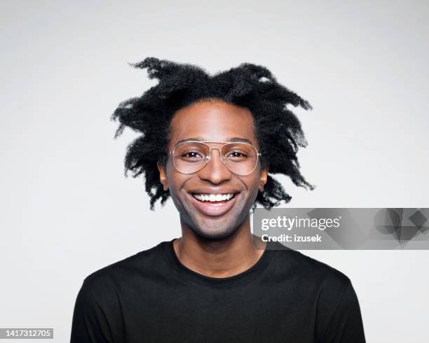 headshot of happy man in black outfit - happy face glasses stockfoto's en -beelden