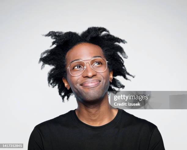 headshot of pleased man in black outfit - black man looking up stock pictures, royalty-free photos & images