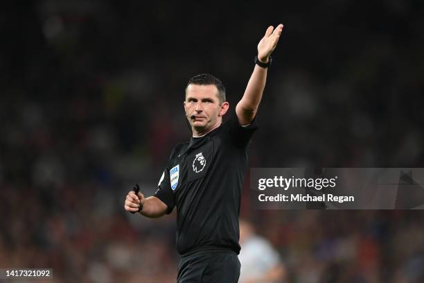 Referee Michael Oliver gestures during the Premier League match between Manchester United and Liverpool FC at Old Trafford on August 22, 2022 in...