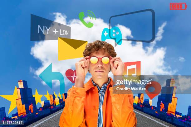 fashionable man wearing smart glasses surrounded by digital icons - digital composite ストックフォトと画像