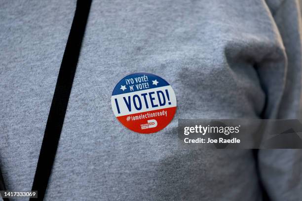 Voter wears an "I Voted" sticker after voting in a polling station on August 23, 2022 in Miami, Florida. Voters across the state cast their ballots...