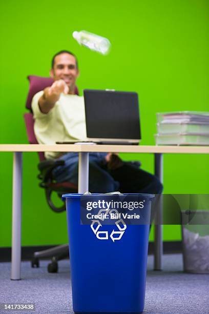 businessman throwing bottle into recycling bin - waste basket stock pictures, royalty-free photos & images