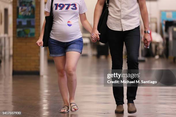 Couple hold hands after voting during Primary Election Day at PS 10 on August 23, 2022 in the Park Slope neighborhood of Brooklyn borough in New York...