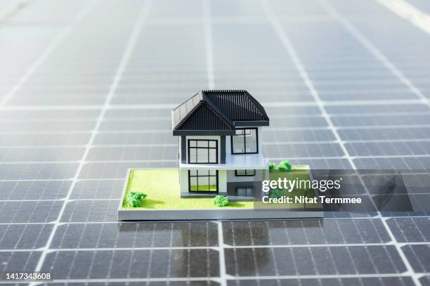 return on energy invested in rooftop solar panels for resident building. house, architecture model design of home ownership, on solar panels. housing development, clean energy, and green building concepts. - clean house stockfoto's en -beelden