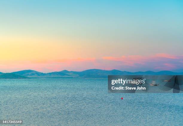 sea at sunset - smooth sailing stock pictures, royalty-free photos & images