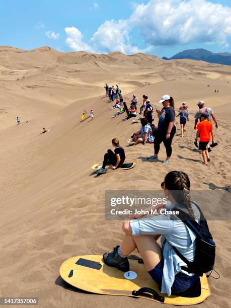 sandboarding at great sand dunes national park, colorado (usa) - sand boarding stock pictures, royalty-free photos & images