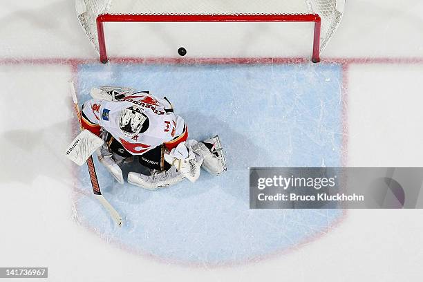 Dany Heatley of the Minnesota Wild scores a goal against Miikka Kiprusoff of the Calgary Flames during the game at the Xcel Energy Center on March...