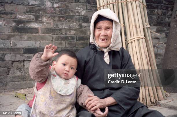 rural chinese grandmother and child - hong kong grandmother stock pictures, royalty-free photos & images