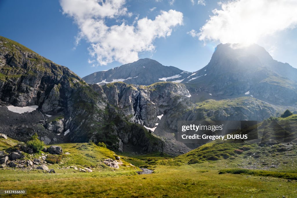 Close up of melting snow on mountain cliff in the Oisans massif in French Alps in summer