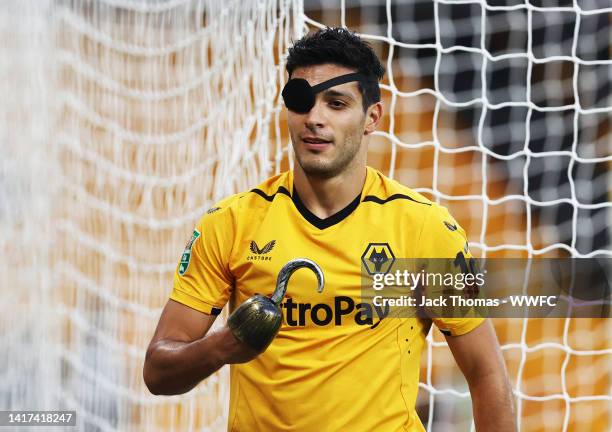 Raul Jimenez of Wolverhampton Wanderers celebrates with a Pirate hook and eye patch after he scores his sides first goal during the Carabao Cup...