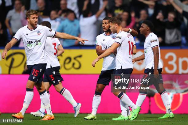 Dion Charles of Bolton Wanderers celebrates with teammates after scoring their team's first goal during the Carabao Cup Second Round match between...