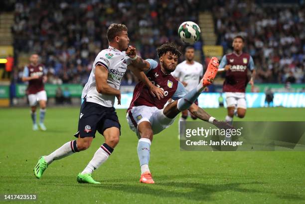 Tyrone Mings of Aston Villa battles with Dion Charles of Bolton Wanderers during the Carabao Cup Second Round match between Bolton Wanderers and...
