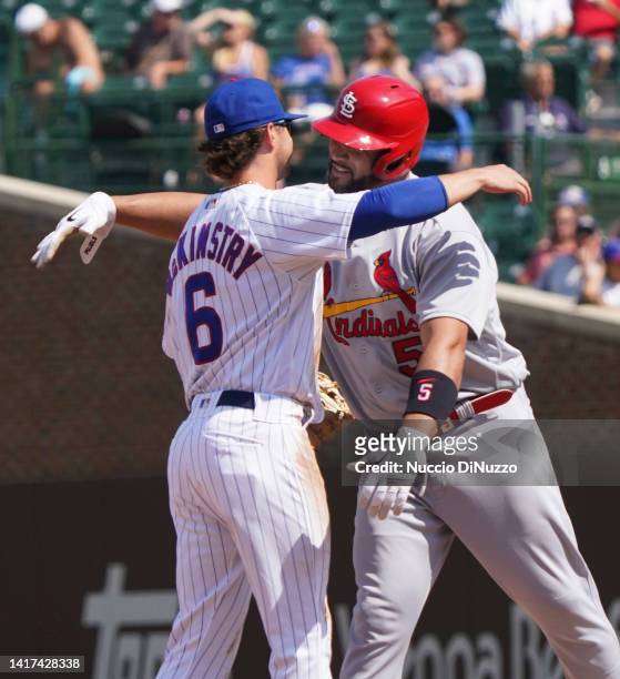 Albert Pujols of the St. Louis Cardinals hugs Zach McKinstry of the Chicago Cubs following his double during the fourth inning of Game One of a...