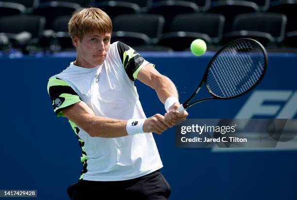 Ilya Ivashka of Belarus returns a shot from Peter Gojowczyk of Germany during their second round match on day four of the Winston-Salem Open at Wake...