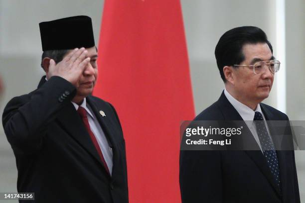 Indonesia's President Susilo Bambang Yudhoyono salutes as he listens to the national anthems with Chinese President Hu Jintao during a welcoming...
