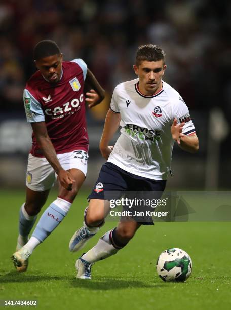 Declan John of Bolton Wanderers competes for the ball with Leon Bailey of Aston Villa during the Carabao Cup Second Round match between Bolton...