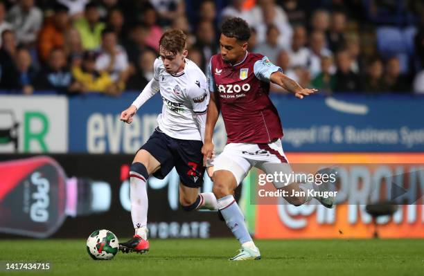 Conor Bradley of Bolton Wanderers battles with Douglas Luiz of Aston Villa during the Carabao Cup Second Round match between Bolton Wanderers and...