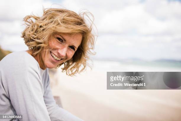 happy blond woman enjoying at beach - 50 ストックフォトと画像
