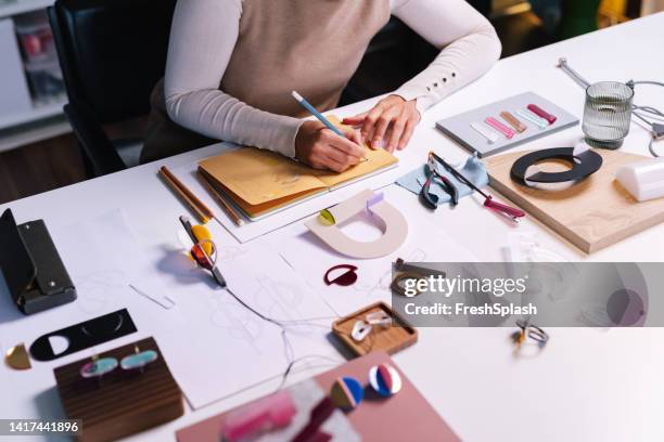 anonymous woman writing in her notebook - jewellery designer stock pictures, royalty-free photos & images