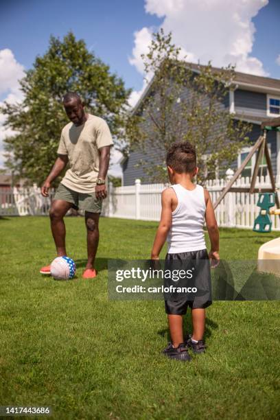 boy playing soccer with dad, passing - baby kicking stock pictures, royalty-free photos & images