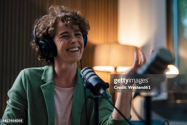 cheerful radio dj wearing headset recording in studio - radio dj stock pictures, royalty-free photos & images
