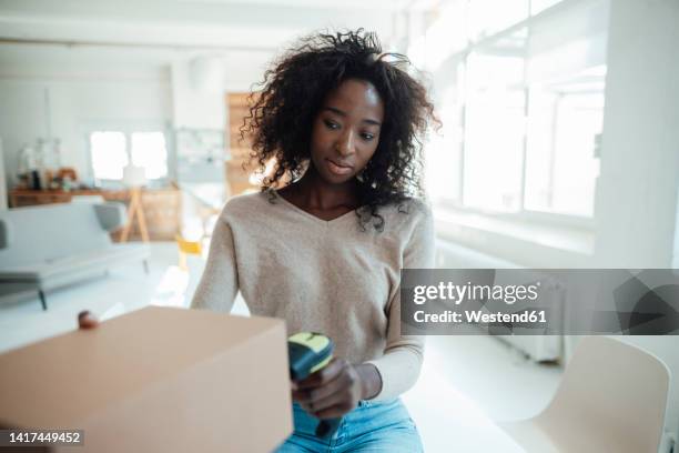 businesswoman scanning bar code on box - bar code ストックフォトと画像