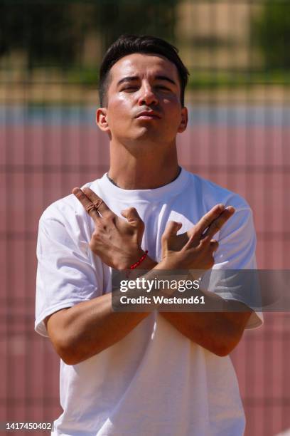 man gesturing finger gun on sunny day - finger guns man stock pictures, royalty-free photos & images