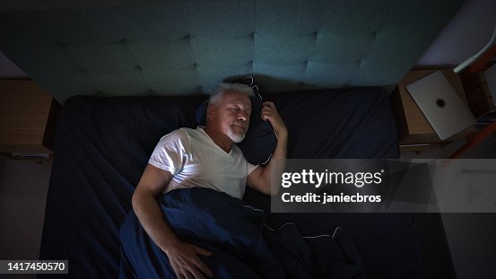 Anxious, mature man trying to sleep at night. Dealing with sleeping disorder Anxious, mature man trying to sleep at night. Dealing with sleeping disorder