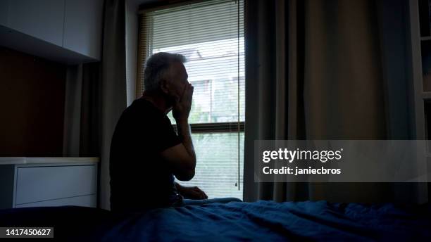 tired,  depressed mature man getting up early in the morning. head in hands - head in hands silhouette stock pictures, royalty-free photos & images