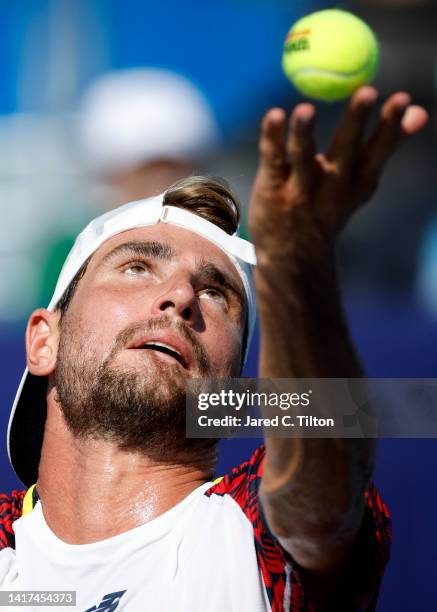 Maxime Cressy of United States prepares to serve to James Duckworth of Australia during their second round match on day four of the Winston-Salem...