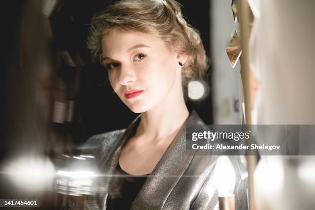 female portrait of young woman at the backstage of fashion week show. lifestyle with people, color photography - fashion show catwalk stock pictures, royalty-free photos & images