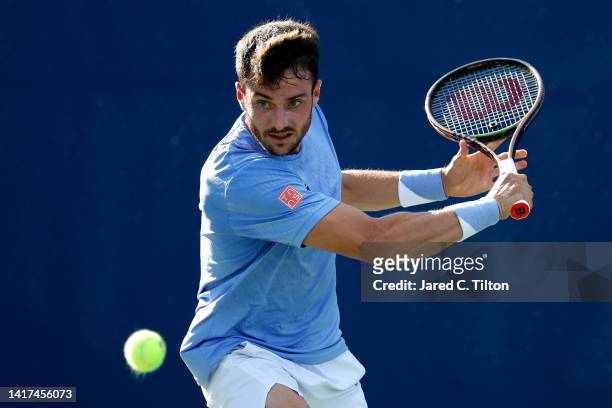 Pedro Martinez of Spain returns a shot to Steve Johnson of United States during their second round match on day four of the Winston-Salem Open at...