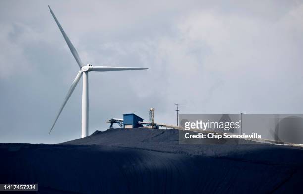 Turbine from the Roth Rock wind farm spins on the spine of Backbone Mountain behind the Mettiki Coal processing plant on August 23, 2022 in Oakland,...
