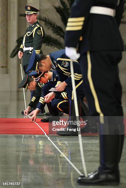 Members of an honour guard use tape measures on the floor to line up as they prepare for a welcoming ceremony for Indonesia's President Susilo...