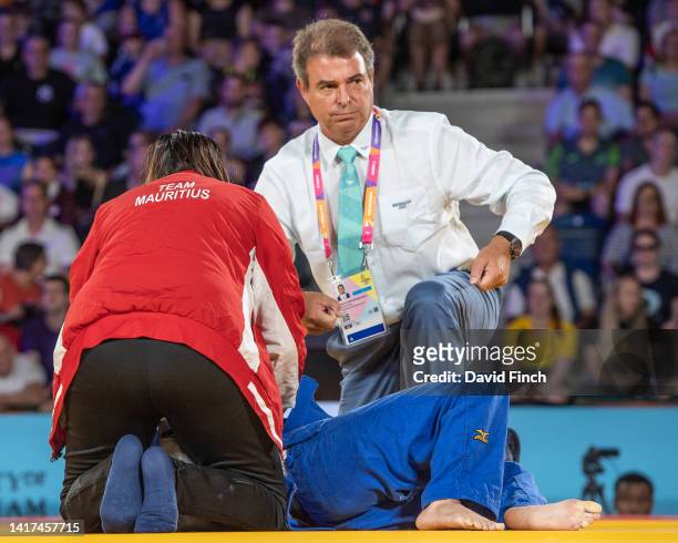 Priscilla Morand of Mauritius feinted after being disqualified in her u48kg bronze medal contest and is attented by a son of Fidel Castro, Dr Antonio...