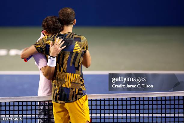 Dominic Thiem of Austria embraces Grigor Dimitrov of Bulgaria at center court following their second round match on day four of the Winston-Salem...