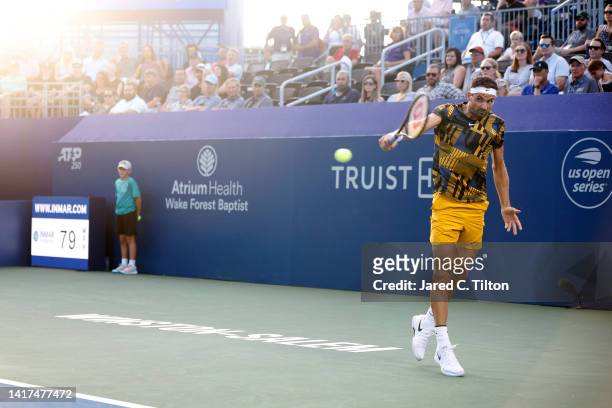 Grigor Dimitrov of Bulgaria returns a shot to Dominic Thiem of Austria during their second round match on day four of the Winston-Salem Open at Wake...