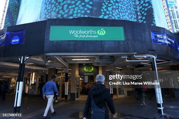 Pedestrians walk past a Woolworths supermarket on George Street on August 24, 2022 in Sydney, Australia. Supermarket chains Woolworths and Coles will...