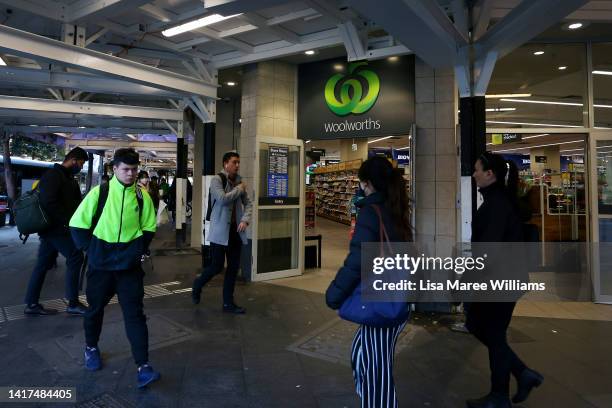 Pedestrians walk past a Woolworths supermarket on George Street on August 24, 2022 in Sydney, Australia. Supermarket chains Woolworths and Coles will...