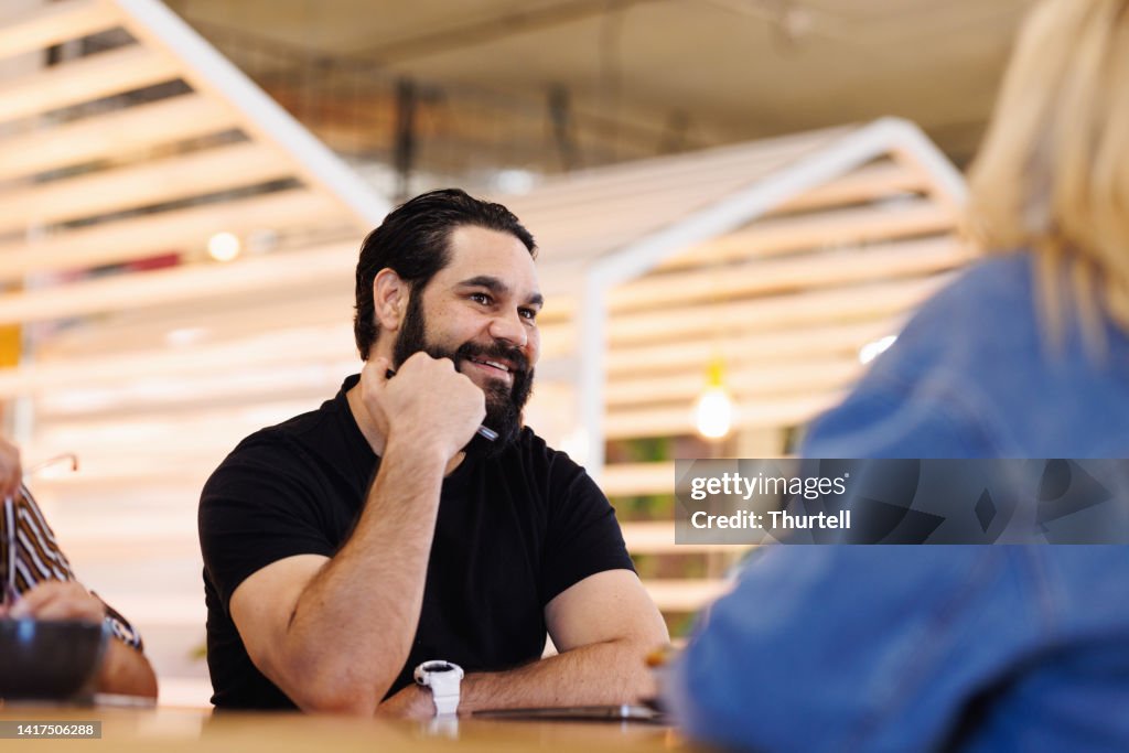 Aboriginal Australian man leading casual group meeting