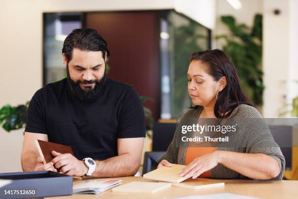 male and female aboriginal australian designers collaborating - aboriginal man imagens e fotografias de stock