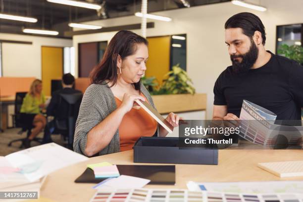 male and female aboriginal australian designers collaborating - creative director stock pictures, royalty-free photos & images