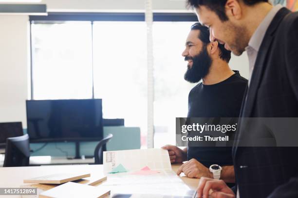 aboriginal australian creative director working with colleague - creative director stock pictures, royalty-free photos & images
