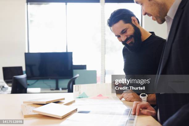 aboriginal australian creative director working with colleague - creative director stock pictures, royalty-free photos & images