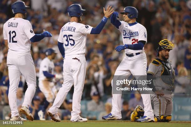 Trayce Thompson of the Los Angeles Dodgers celebrates his three run homerun with Cody Bellinger and Joey Gallo, to take a 4-0 lead in front of Omar...