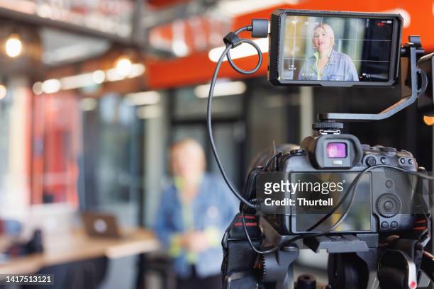 female aboriginal australian presenting own vlog - interview event stock pictures, royalty-free photos & images