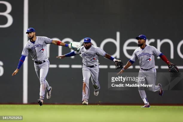 Lourdes Gurriel Jr. #13, Jackie Bradley Jr. #25 and Teoscar Hernandez of the Toronto Blue Jays celebrate after defeating the Boston Red Sox 9-3 at...