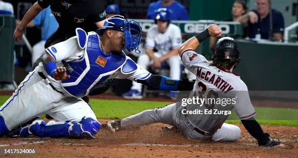 Jake McCarthy of the Arizona Diamondbacks is tagged out by Salvador Perez of the Kansas City Royals as McCarthy tries to score in the ninth inning at...