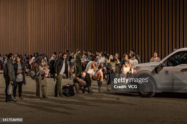 Immigrants are processed by the U.S. Border Patrol after crossing the border from Mexico on August 20, 2022 in Yuma, Arizona.